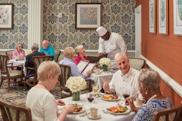 seniors sharing a delightful meal in an independent living community setting