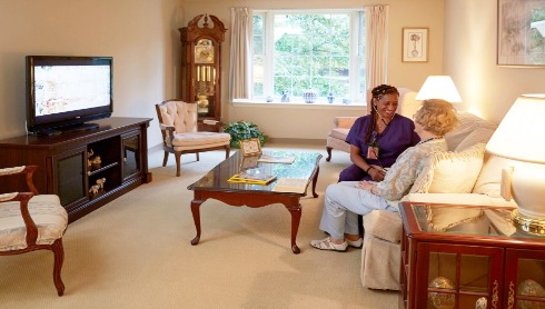Senior lady with a nurse in her room concept image for skilled nursing care.