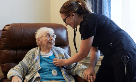 Older woman getting cared for by nurse