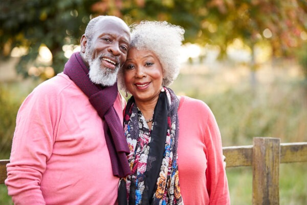 A senior couple spends time outdoors in the independent living community after spending time with family members.