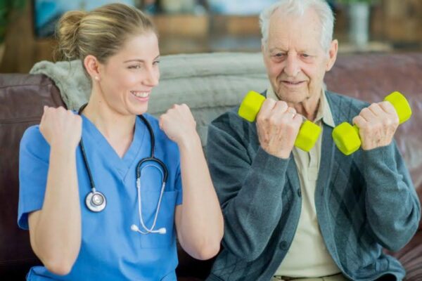 senior man exercising with light weights alongside a nurse, illustrating ccrc meaning research