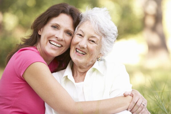 Daughter embracing her senior mother warmly in one of the assisted living communities