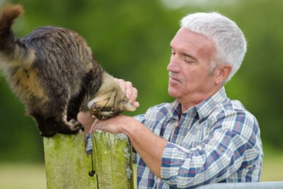 Retired man spending time with his cat