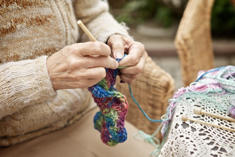 Senior learning to knit in retirement