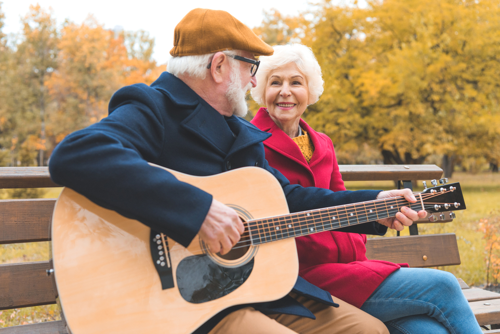 Riddle Village music nursing home Senior learning guitar