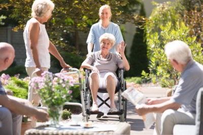 new resident waving to friends at retirement center