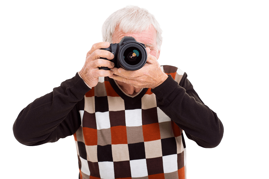 Senior man photographing items for memories as part of the downsizing process 