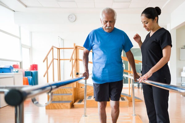 Senior man undergoing mobility therapy during his short term rehabilitation session.