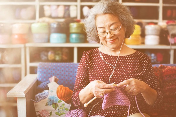 Senior woman knitting needles.