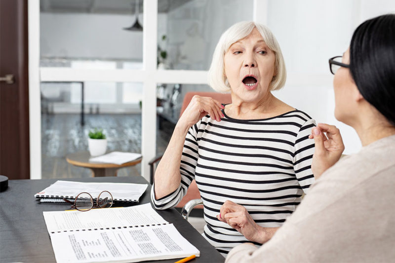 Senior woman undergoing speech therapy after a stroke.