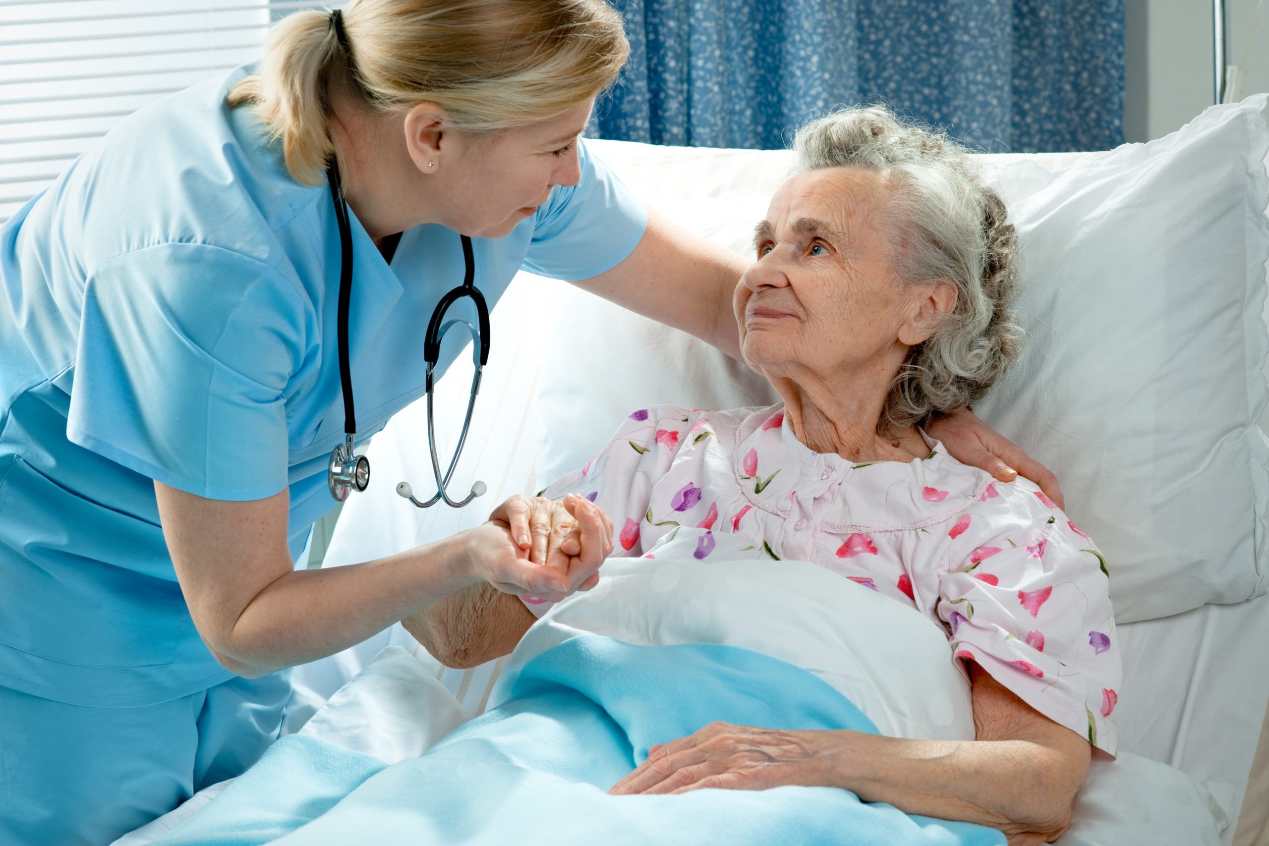 Skilled nurse assisting her elderly patient. member of our full-service therapy department in Media, PA working with a resident
