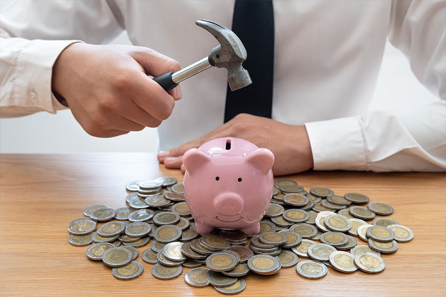 Smashing a piggy bank concept of financial planning affected by myths of retirement