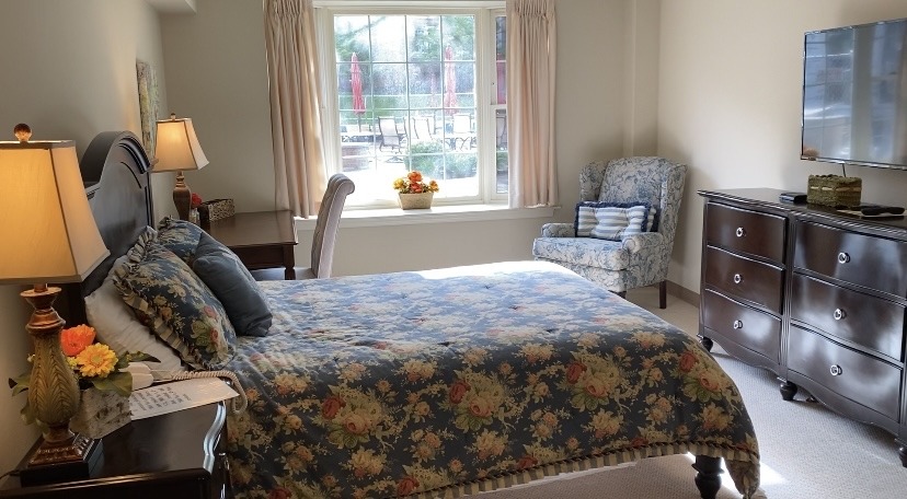 Spacious bedroom at riddle village respite care apartments, where family members can visit