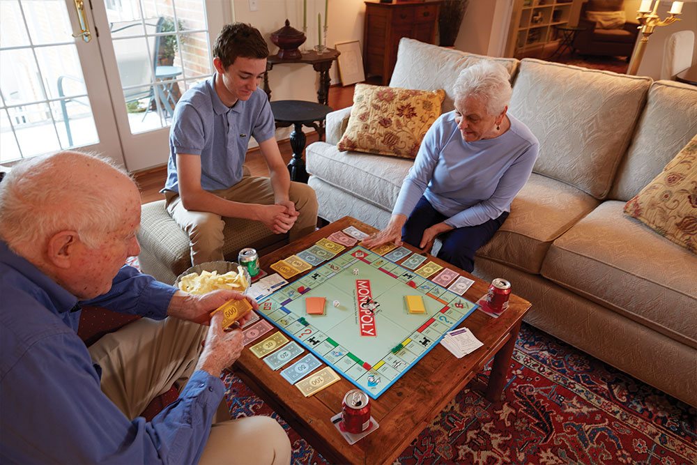 Playing Games With Family - Riddle Village Retirement Community playing-board-games-independent-living-family