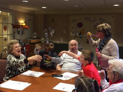 kids and residents play with bubbles in 2017