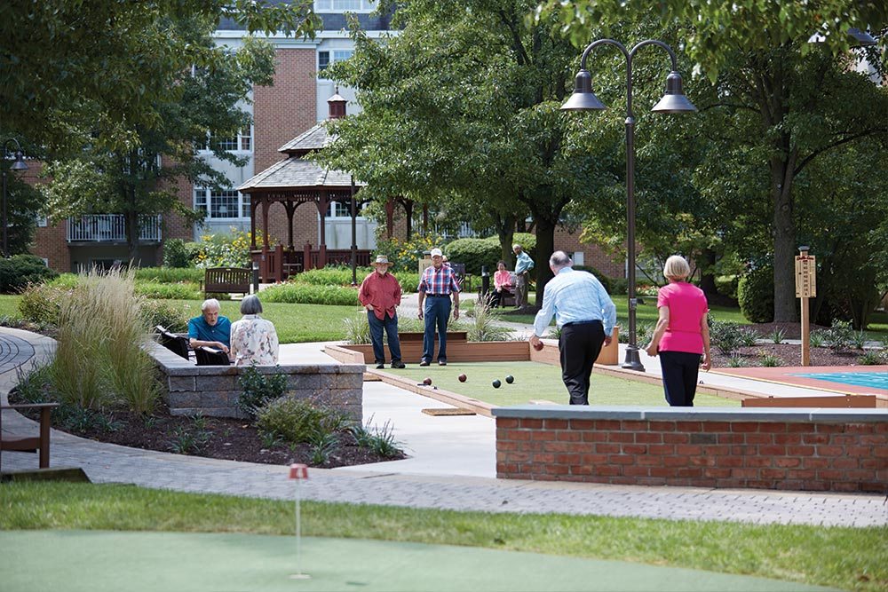 residents-playing-games-in-courtyard-retirement