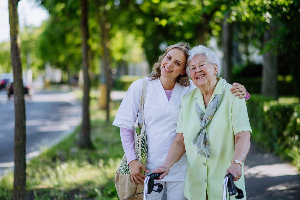 A licensed caregiver and resident enjoying time together in a welcoming community setting, illustrating the benefits of senior living care
