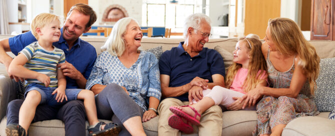 Visitor'S Guide: Making The Most Of Your Time At Riddle Village 1 grandparents enjoying a family visit in their bright living room, featured in our community visitors guide.